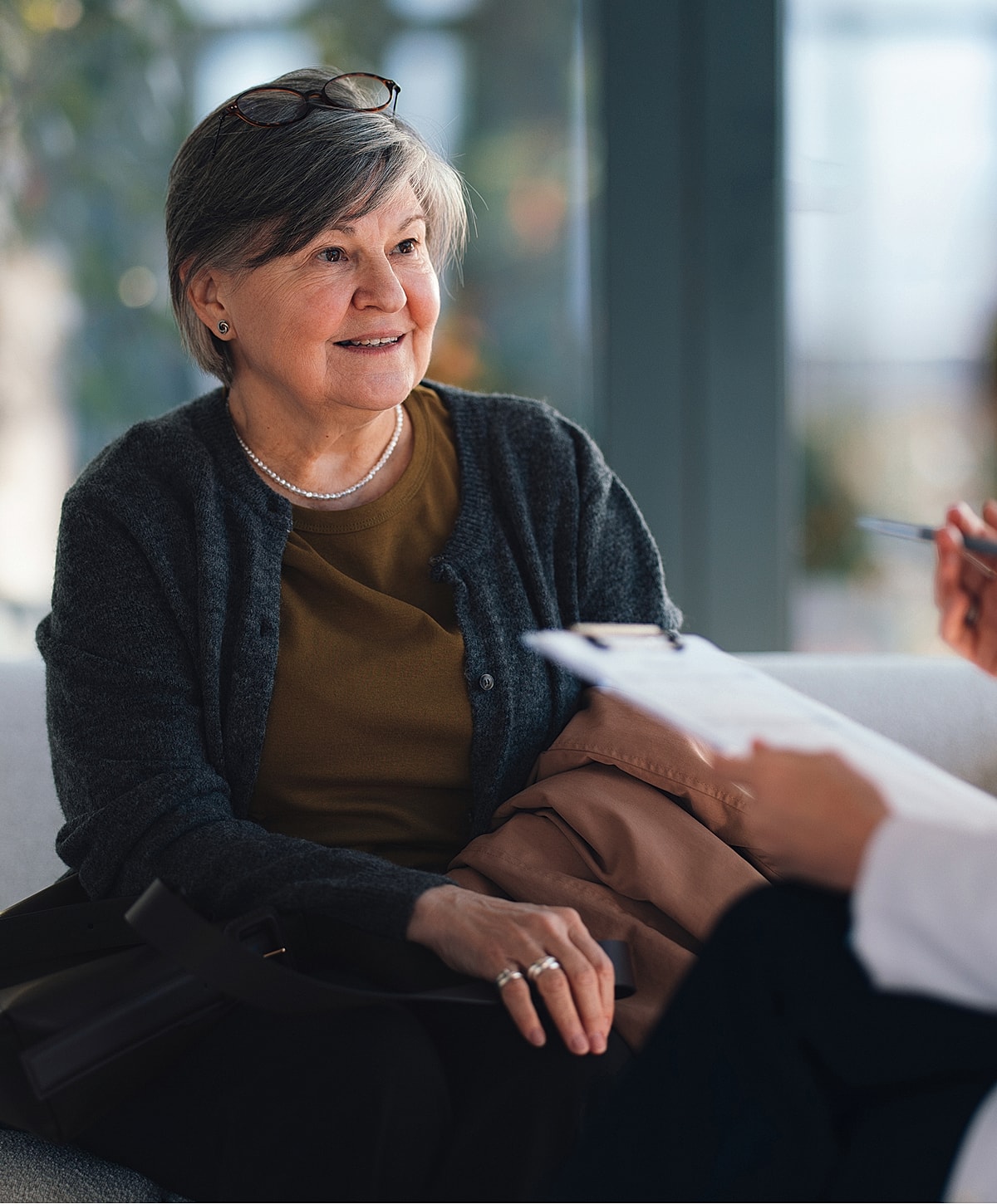 Older woman engaged in conversation, listening attentively.