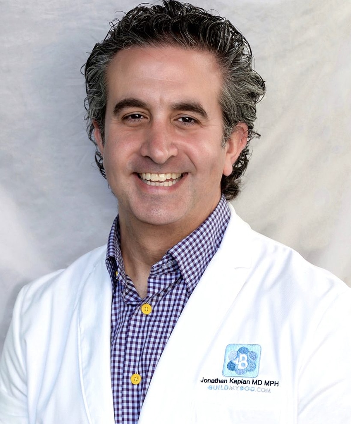 Smiling doctor in white coat, professional portrait.