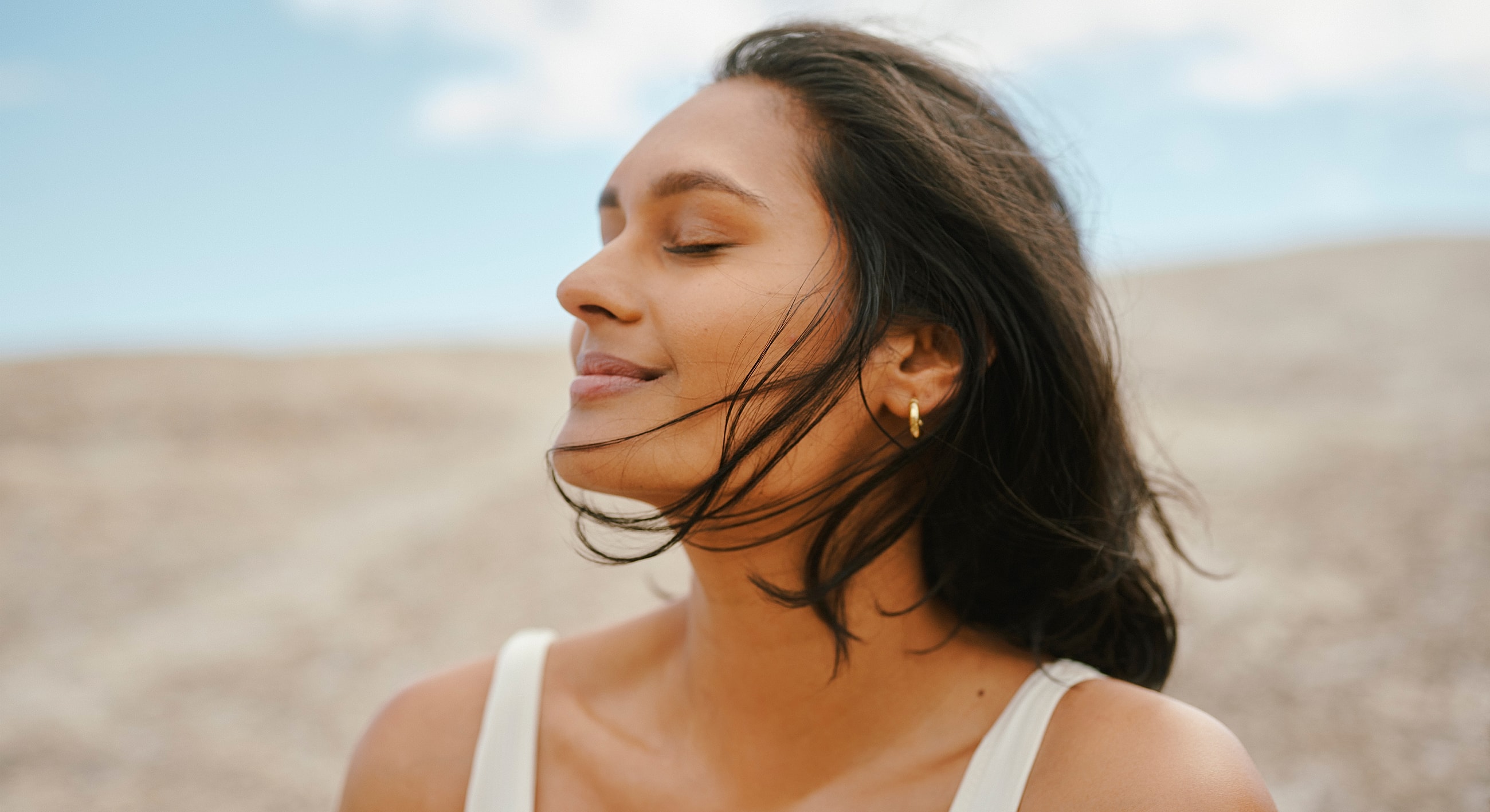 Woman enjoying a moment of serenity outdoors.